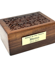 A wooden pet urn with a hand-carved tree of life design on the lid, featuring a brass name plate.